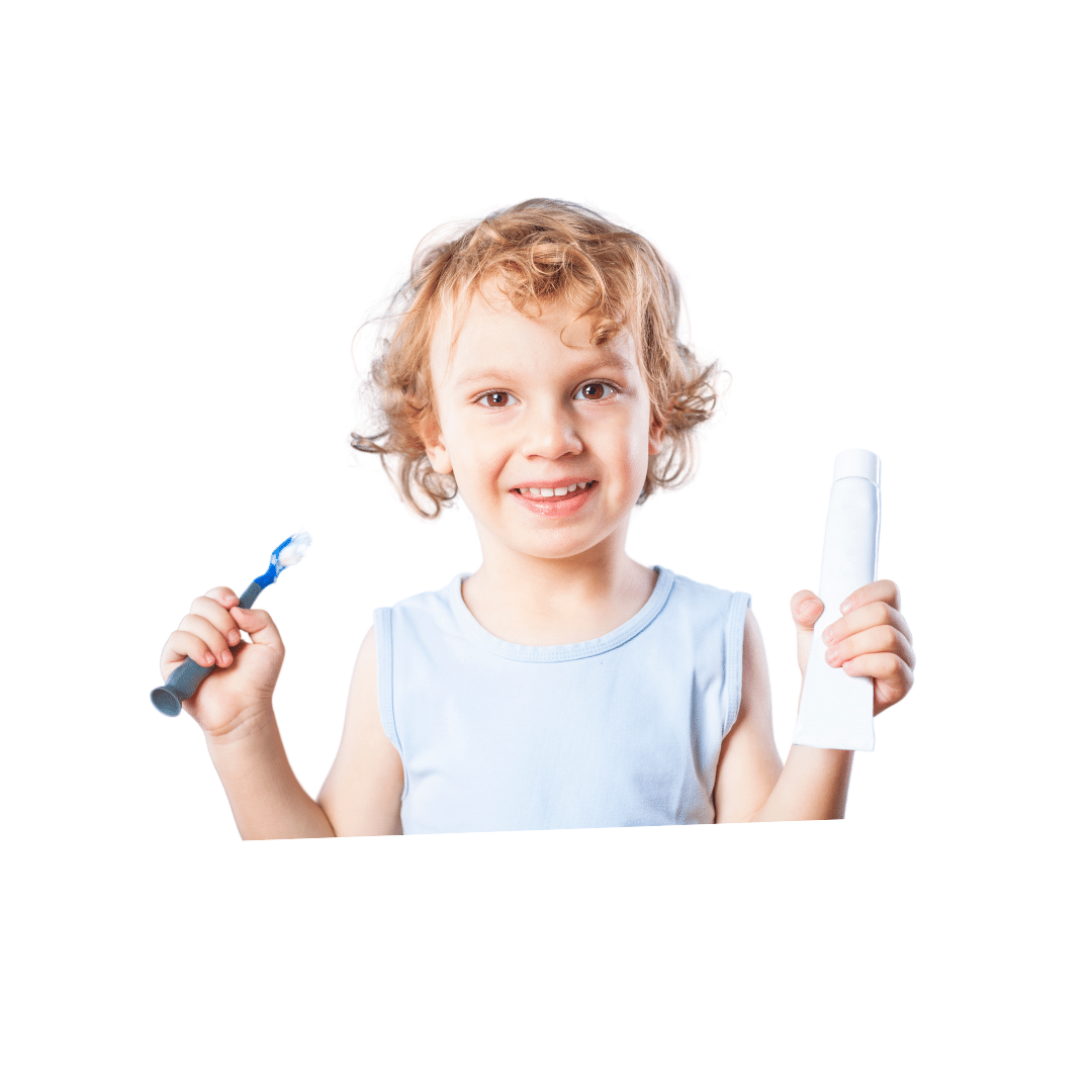 Young boy smiling with toothbrush and toothpaste in hand