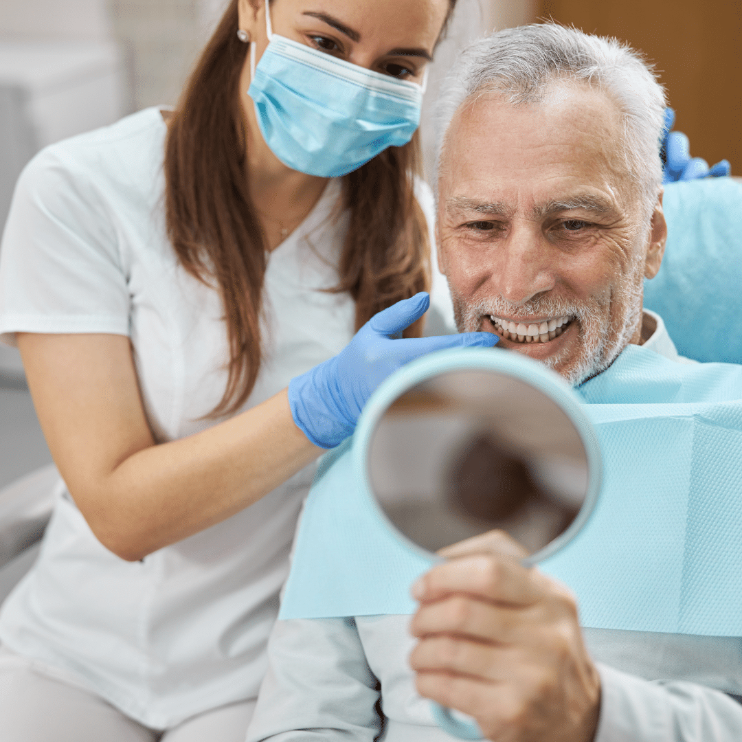 Man seeing his smile at dentist after implants